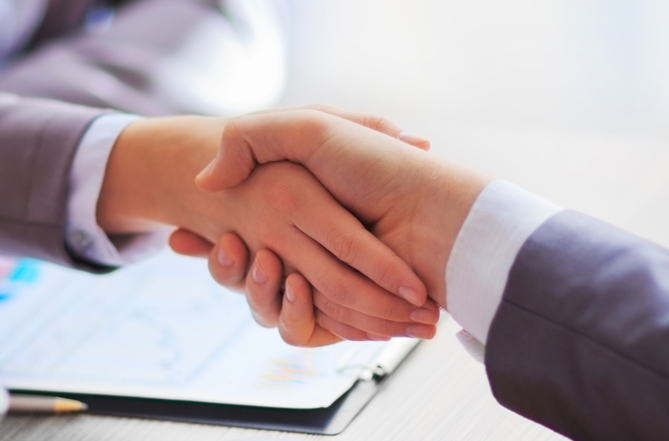 Business People Shaking Hands After Mediation